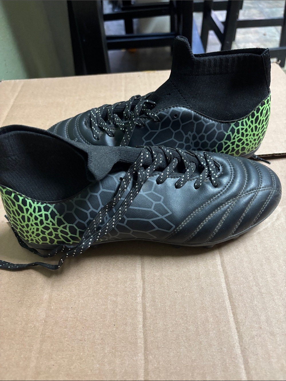 Black Soccer Cleats with Neon Green Heel Detail